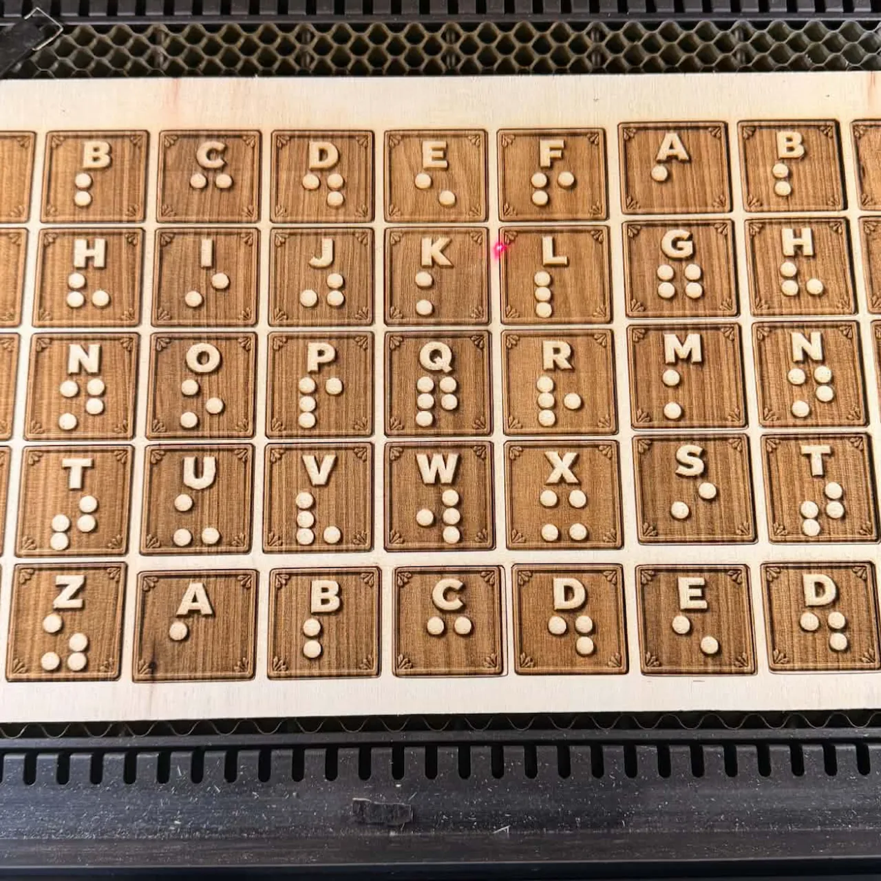 Braille Letter cutouts light brown plywood sheet test grid